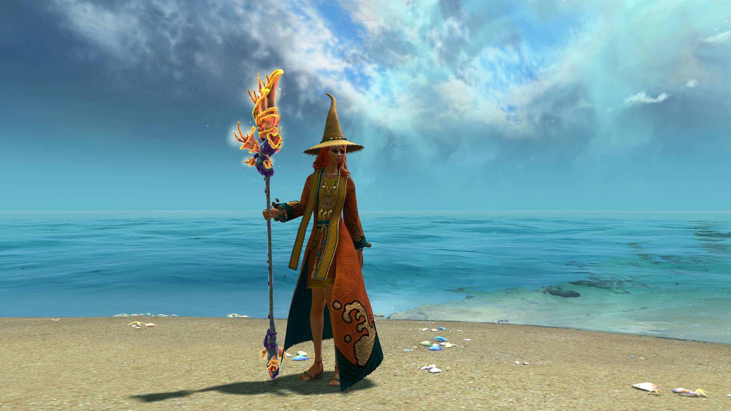 A female elementalist stands on a beach. She is wearing the Seaside Scholar armor which has a wizardly beach vibe. She carries a magical staff made of coral.